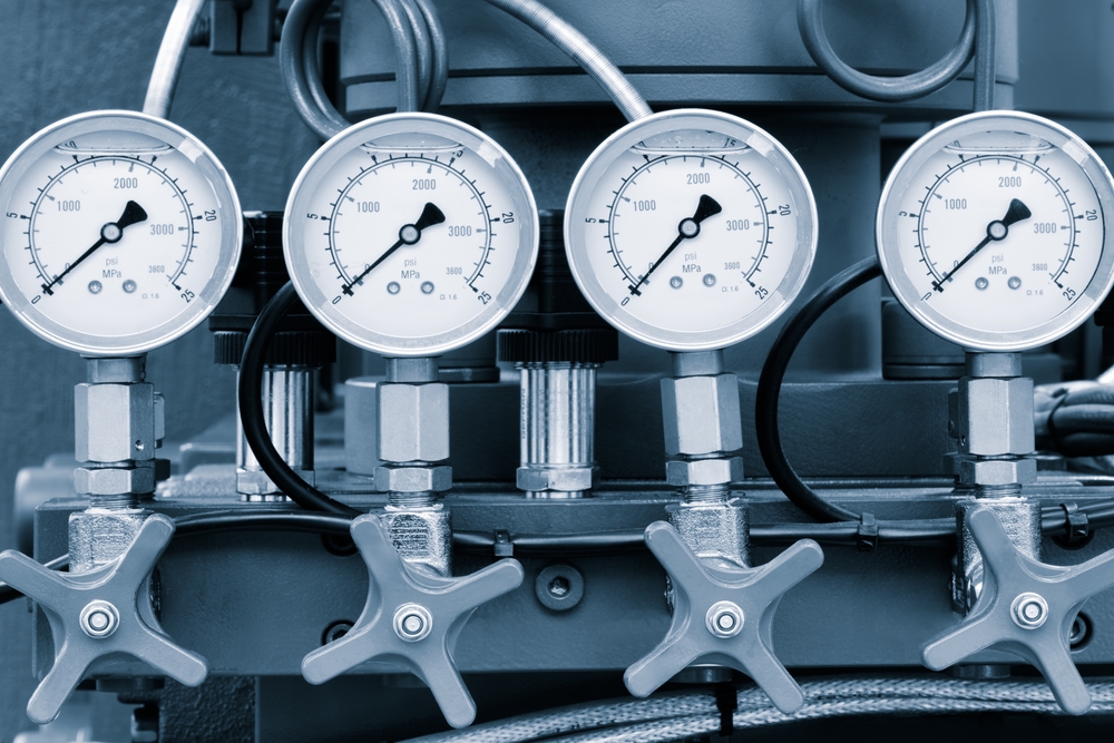 A macro photograph of a synchronized industrial gauge and valve stack, representing the transition from informal AI use to a sanctioned, governance-grade architecture.