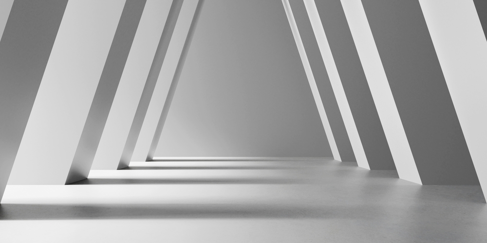 High-contrast architectural photograph of symmetrical, monolithic white concrete pillars angling inward to support a vaulted hallway ceiling, creating rhythmic patterns of sharp geometric shadows to visually represent the balanced, load-bearing operating partnership between the CMO and the CFO.